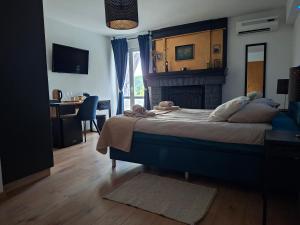 a bedroom with a large bed with a fireplace at Petra Rooms and Apartments in Rab