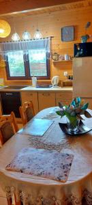 a kitchen with a table with a bowl of fruit on it at TLdomki in Radęcin