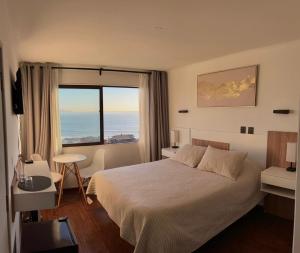 a bedroom with a bed and a large window at Hotel Camino del Alto Reñaca in Viña del Mar +63 photos
