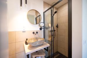 a bathroom with a sink and a shower at Herberg In de Valk in Middelstum +3 photos