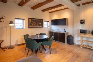 a dining room with a table and chairs in a room at Herberg In de Valk in Middelstum