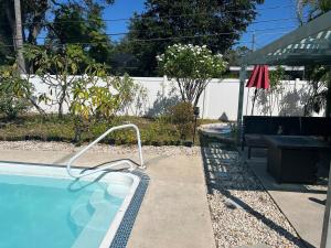 a swimming pool with a hand rail in a yard at Artsy Oasis in Clearwater in Clearwater