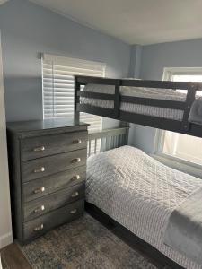 a bedroom with two bunk beds and a dresser at Artsy Oasis in Clearwater in Clearwater +15 photos