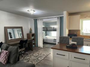 a living room with a desk and a bedroom at Artsy Oasis in Clearwater in Clearwater