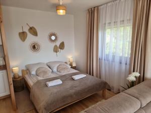 a bedroom with a large bed and a window at Apartament Dwa Słońca in Gliczarów
