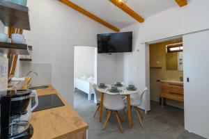 a kitchen with a table and chairs in a room at House Guesthouse Stipe in Lopar +19 photos