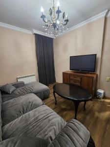 a living room with two beds and a flat screen tv at Luma home in Angisa