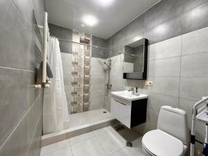 a bathroom with a shower and a toilet and a sink at Luma home in Angisa