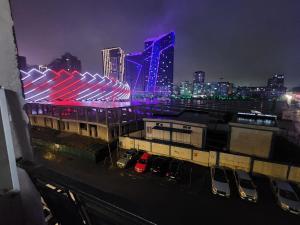a city skyline at night with cars parked in a parking lot at Luma home in Angisa +2 photos