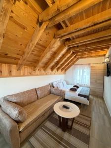 a living room with a couch and a table at Lux Studio Apartments in Žabljak