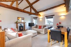 a living room filled with furniture and a fireplace at Carleton Mill Cottage in Carlisle