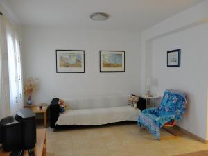 a living room with a couch and a chair at Apartaments Bonaventura 24 in Sitges