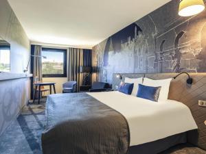a hotel room with a large bed and a desk at Mercure Budapest Castle Hill in Budapest +136 photos