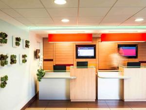 an office cubicle with a person in the background at ibis Massy in Massy