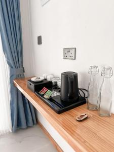 a table with a coffee maker and two glass bottles at Boli Dhigurah in Dhigurah +41 photos