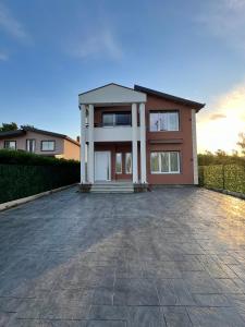 a house with a driveway in front of it at Sunset Aura Riverside Villa & Pool in Draç