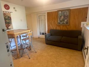 a living room with a couch and a table at Manor guesthouse in Vancouver