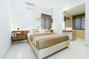 a bedroom with a large bed in a white room at Archontiki Elite Villa - Private Pool, Chania in Vryses +41 photos