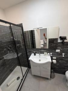 a bathroom with a sink and a shower and a toilet at Residenza Delle Isole in Piombino