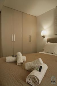 a bedroom with two towels on a bed at G&K House Garden in Messini
