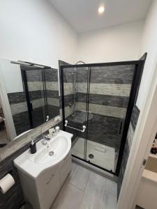 a bathroom with a sink and a glass shower at Residenza Delle Isole in Piombino