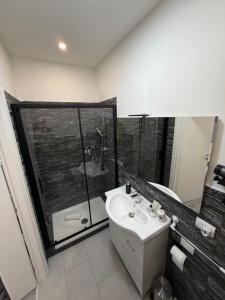 a bathroom with a sink and a glass shower at Residenza Delle Isole in Piombino +14 photos