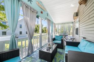 a screened porch with chairs and a table at One Peace Cottage in Deep Hole +17 photos