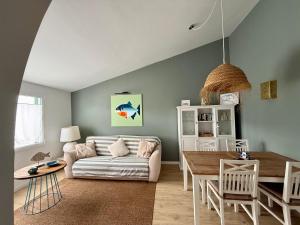 a living room with a couch and a table at Xalet Son Favaritx by GMHouse Menorca in Cala en Bosc