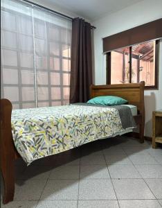a bed sitting in a room with a window at ROSETTA Café & Camas in La Serena +3 photos