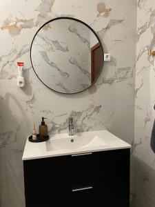 a bathroom with a sink and a mirror on the wall at Meira House in Belinho