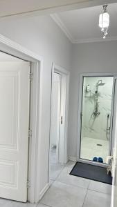 a white room with a shower and a mirror at Astara Villa Kiraye in Astara