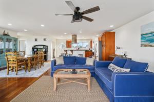 a living room with a blue couch and a table at Paradise in Chincoteague
