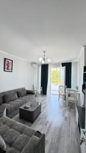 a living room with a couch and a table at Astara Villa Kiraye in Astara