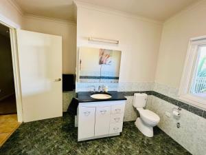 a bathroom with a toilet and a sink at Treetops Escape Albury in Albury +38 photos