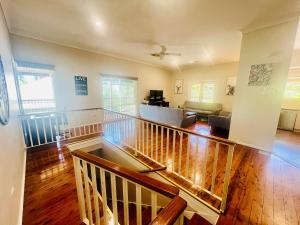 a living room with a staircase and a living room at Treetops Escape Albury in Albury
