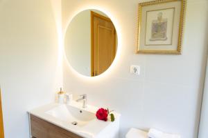 a bathroom with a sink and a mirror at Suite em Viana do Castelo in Viana do Castelo