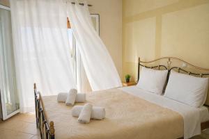 a bedroom with a large bed with towels on it at Villa Nirvana - Sea View Maisonette in Roda, Offering Tranquility and Comfort on the Enchanting Northern Coast of Corfu in (( Litherés )) +46 photos
