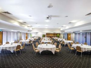 a dining room with tables and chairs at Mercure Townsville in Townsville