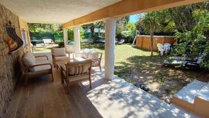 a patio with chairs and a table and a table at Maison Saint-Raphael - Les Vignes in Saint-Raphaël