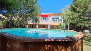 a swimming pool in front of a house at Maison Saint-Raphael - Les Vignes in Saint-Raphaël