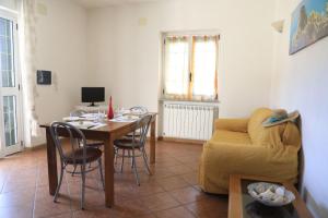 a living room with a table and a couch at House Mimma Tropea in Santa Domenica