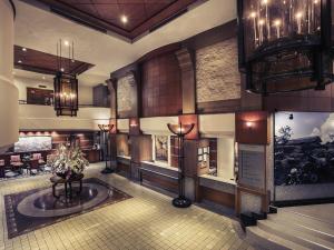 a lobby of a hotel with chandeliers at Mercure Chiang Mai in Chiang Mai