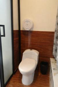 a bathroom with a toilet and a sink at Tungurahua Eco Lodge INN BAÑOS in Quillullaco