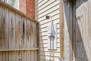a shower on the side of a wooden fence at Precious Time in Chincoteague