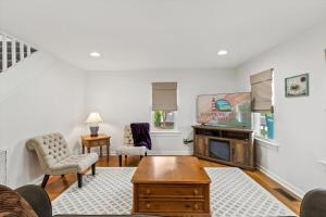 a living room with a fireplace and a tv at Precious Time in Chincoteague