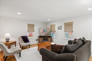 a living room with two couches and a tv at Precious Time in Chincoteague +36 photos