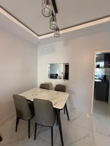 a dining room with a table and chairs at Central place in Lusaka +8 photos