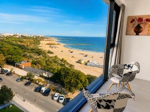 a room with a window with a view of a beach at Maritimo ApartHotel in Constanţa