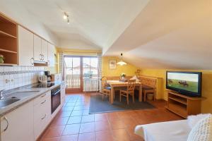 a kitchen with a table and a dining room at Gästehaus Gruber in Piding