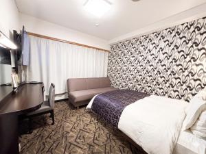 a hotel room with a bed and a desk at APA Hotel Kitakami Ekinishi in Kitakami